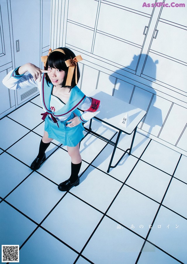 A woman in a school uniform standing in front of lockers.