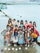 A group of young women posing for a picture in front of a body of water.