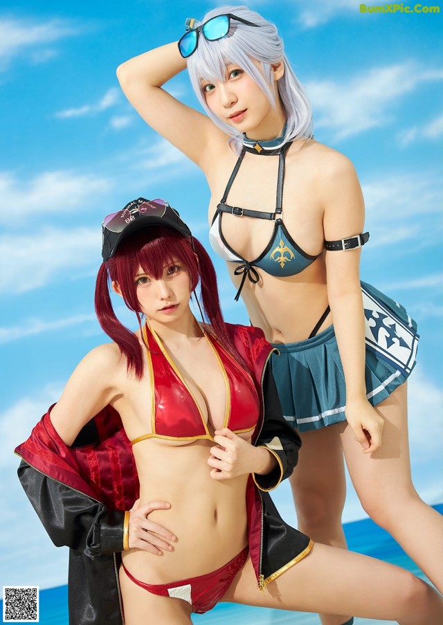 A couple of women standing next to each other on a beach.